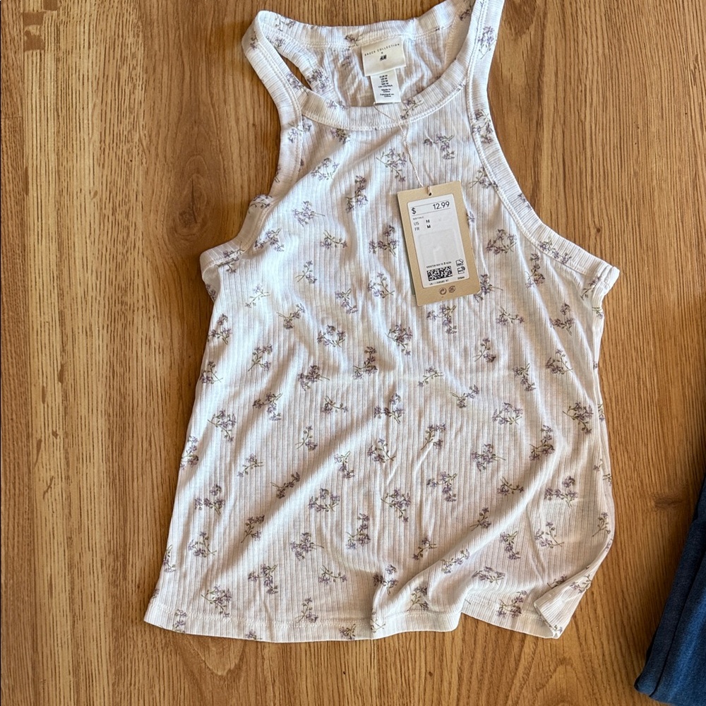 New H&M tank top. Off white with flowers . Size M. Never worn.
